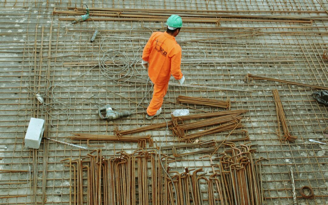 Worker installing metal bars.