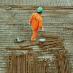 Worker installing metal bars.